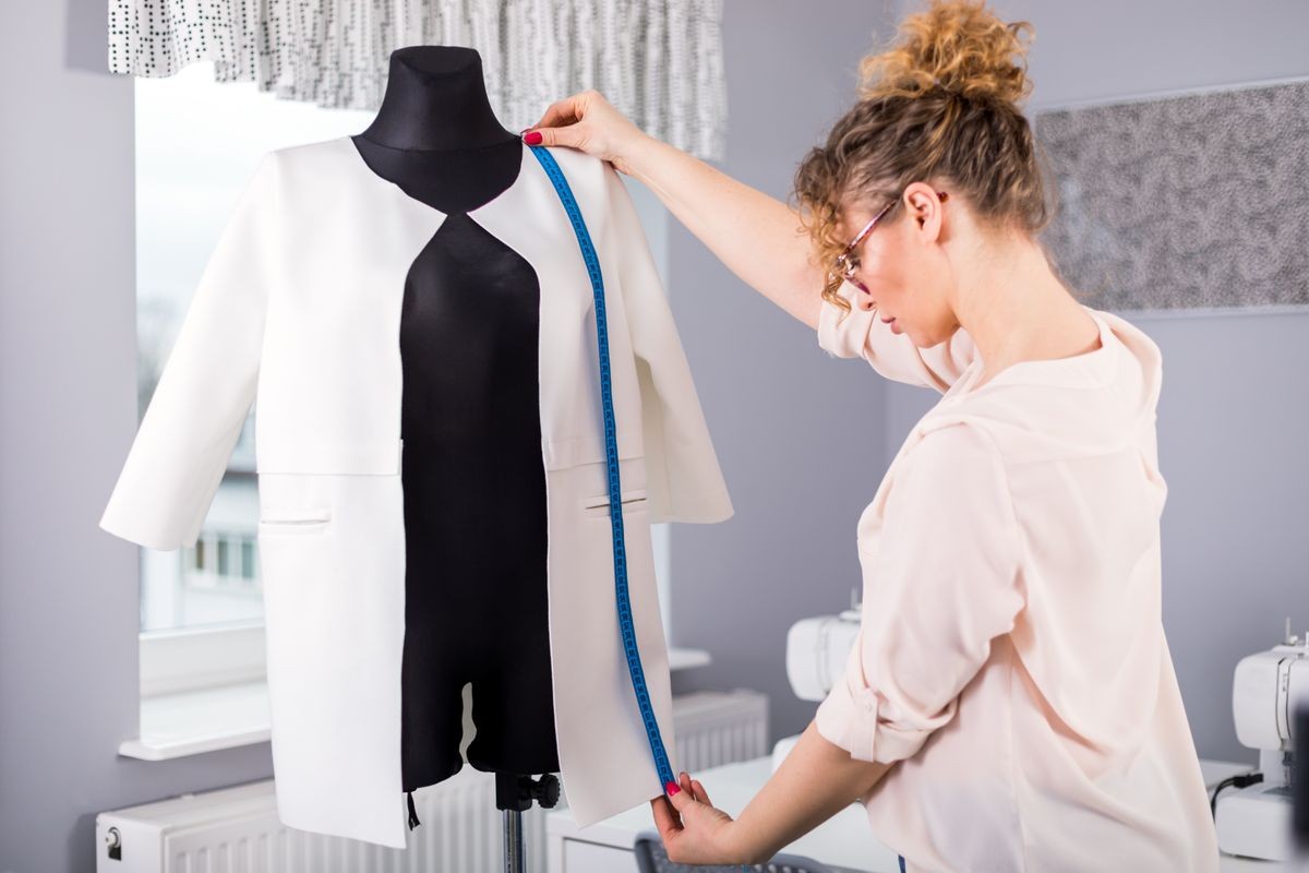 Tailor in her workshop, like a career coach preparing a customized job search strategy